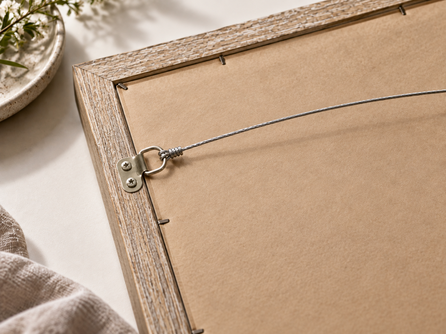 Back of framed portrait showing finished backing and hanging wire